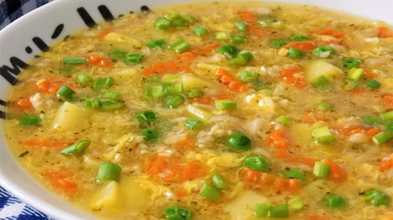 Hot healthy oatmeal soup with vegetables.