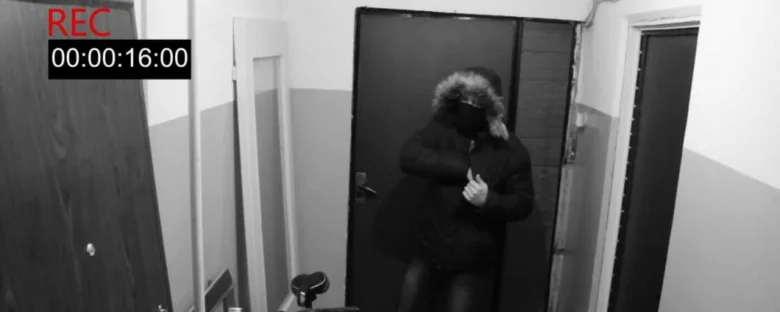 Záznam z bezpečnostní kamery v chodbě s podezřelou osobou.