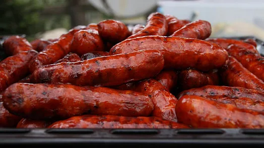 Pile of freshly grilled and ready-to-eat sausages.